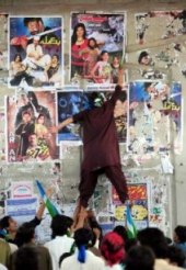 JI workers tearing film posters