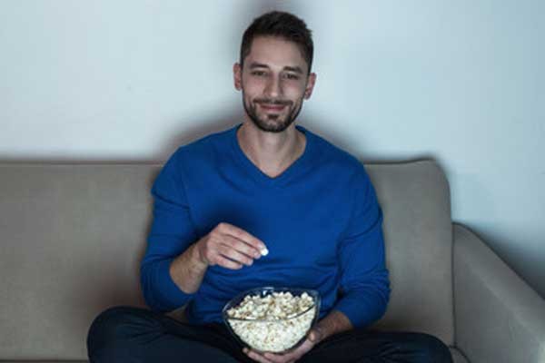 man eating popcorn